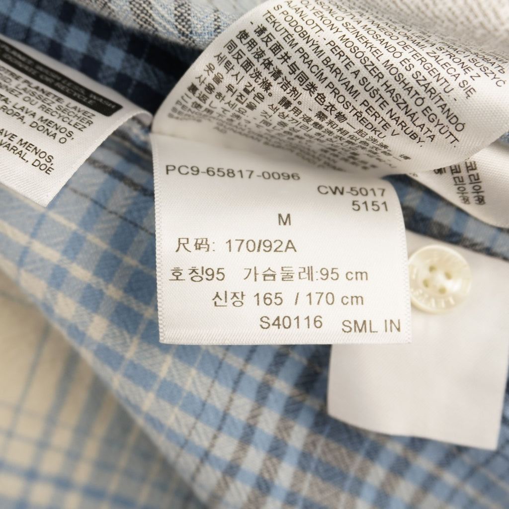 Camicia Levi's modello Western Pearl Snap a maniche corte, fantasia a quadri plaid azzurro, blu e beige. Dettaglio bottoni a pressione madreperla, taschini a punta e Red Tab originale. Taglia M in ottime condizioni vintage.