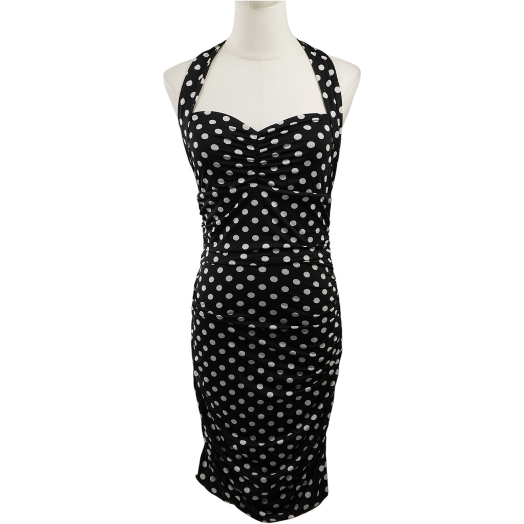 Abito tubino GUESS originale a pois nero e bianco, vista frontale intera su manichino con scollo a cuore e spalline halter.