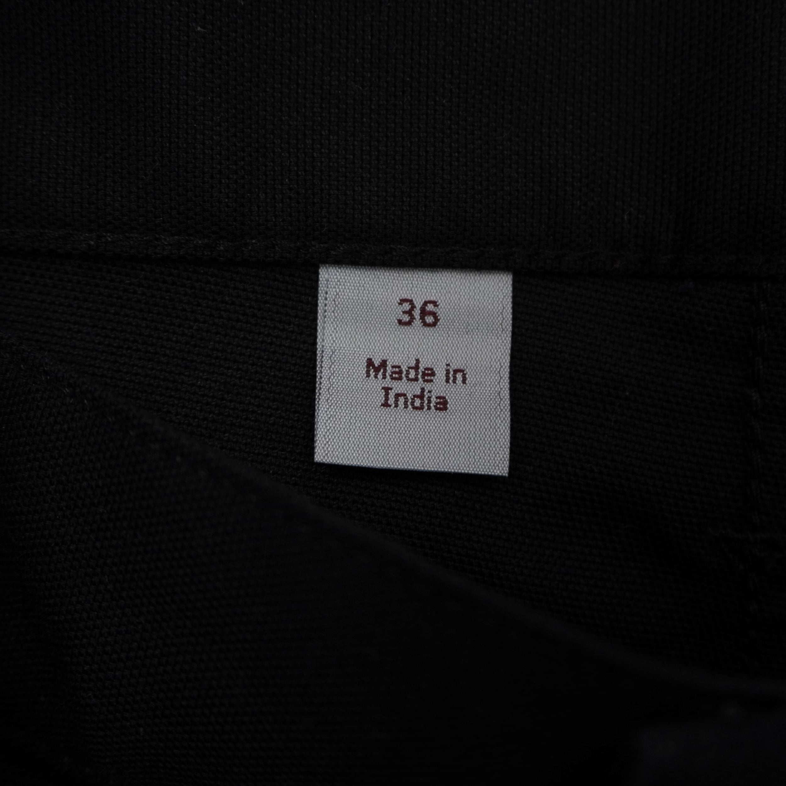 Dettaglio dell'etichetta di lavaggio interna bianca Carhartt WIP con codici della collezione Primavera 2019 e taglia W36
