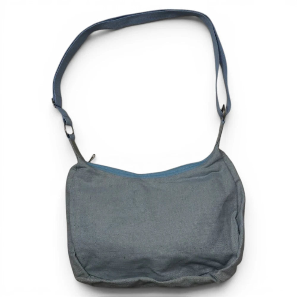  Vista d'insieme della borsa a spalla morbida stile hobo firmata Champion con tracolla azzurra regolabile stesa.