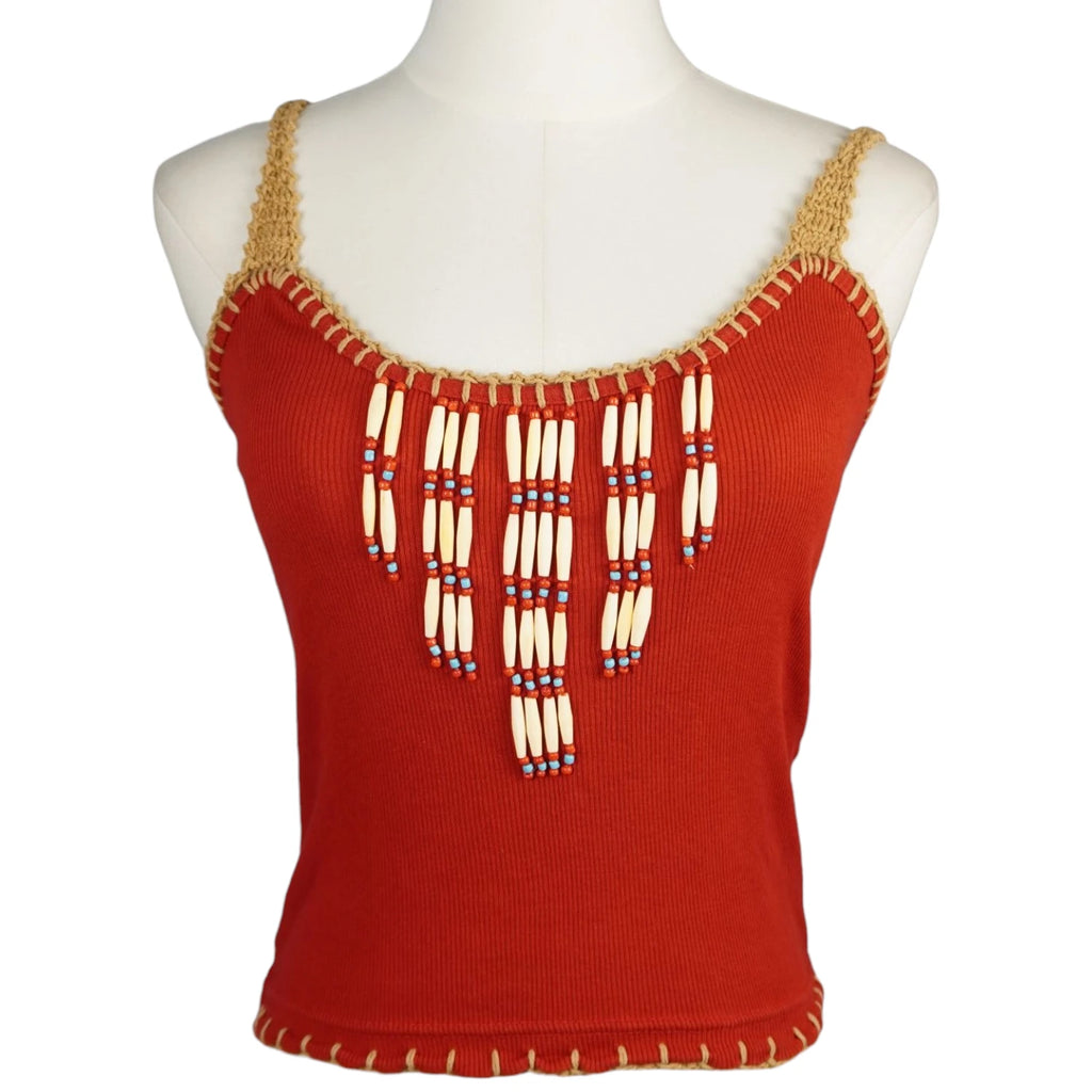 Canotta a coste rossa da donna stile boho-chic del brand Machu Picchu con ricamo etnico di perline bianche sul décolleté e finiture beige all'uncinetto su manichino.