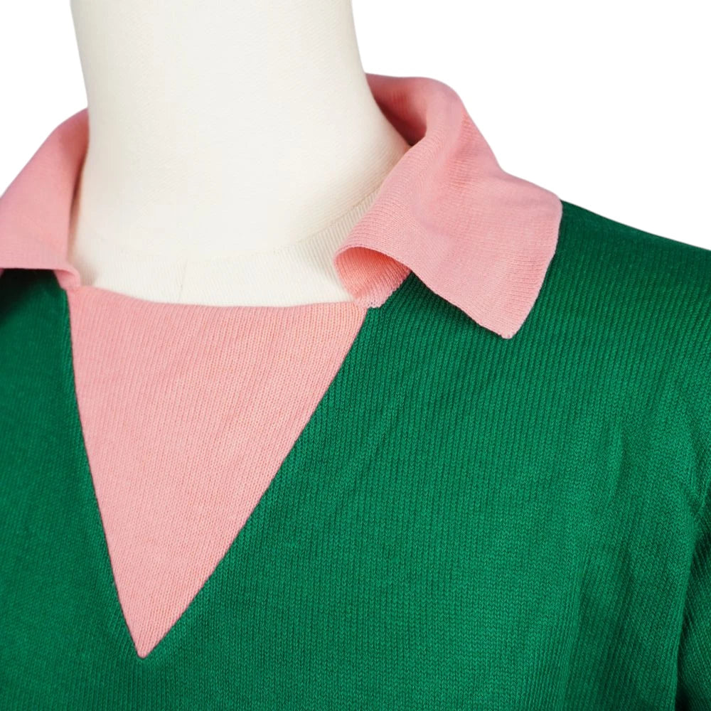 Inquadratura ravvicinata dello scollo a V con inserto e colletto a polo rosa su maglia verde