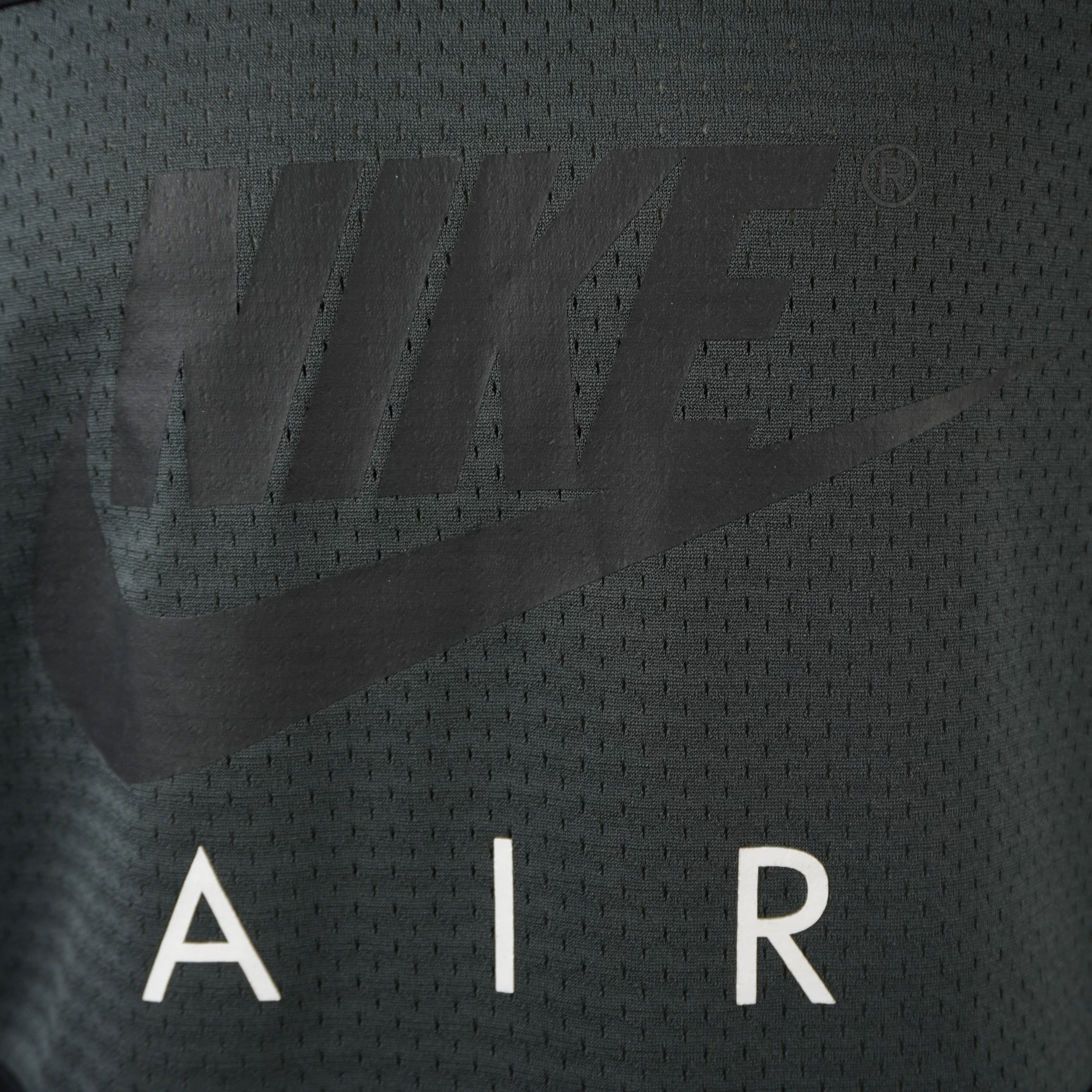 Primo piano del logo Nike Air serigrafato sul petto con finitura opaca e scritta AIR bianca a contrasto.
