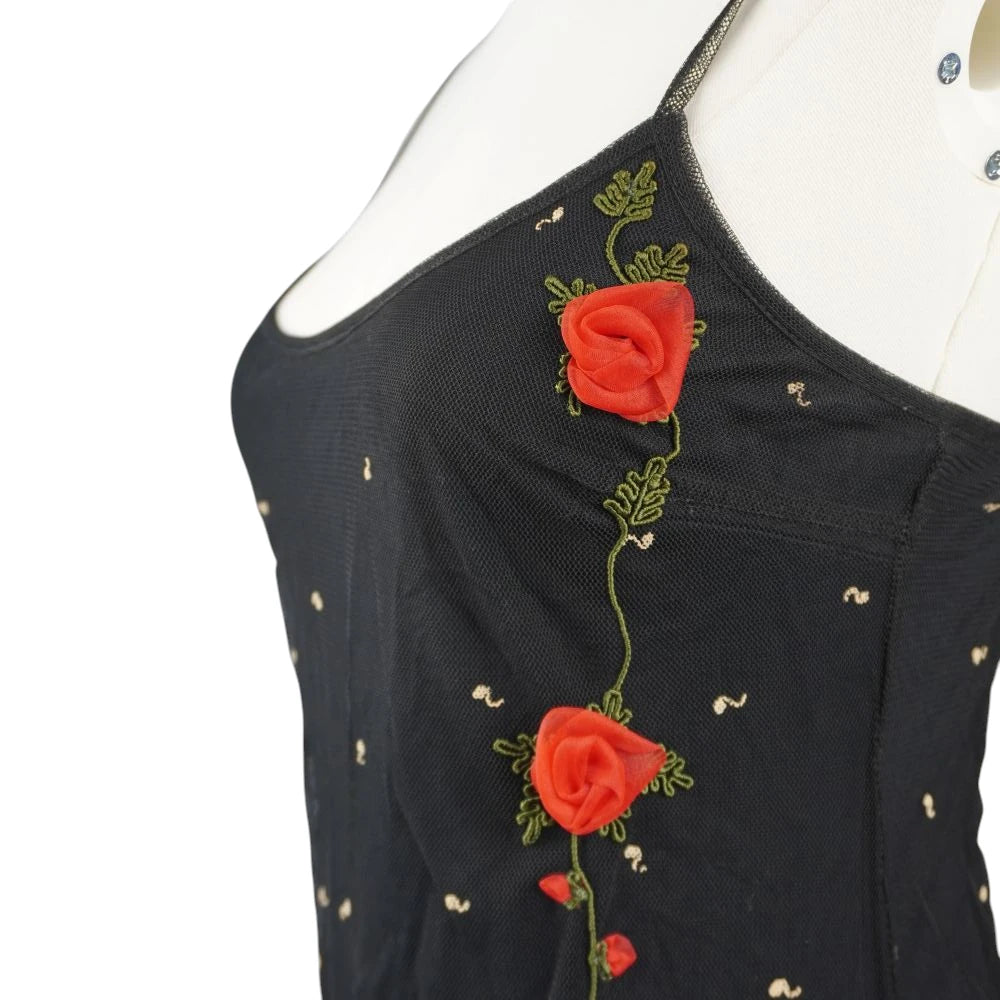  Inquadratura ravvicinata laterale delle tre rose rosse tridimensionali in chiffon applicate a rilievo con stelo verde ricamato.