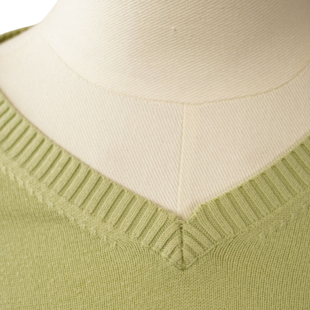 Primo piano dello scollo a V con finitura a costine del pullover da uomo verde.