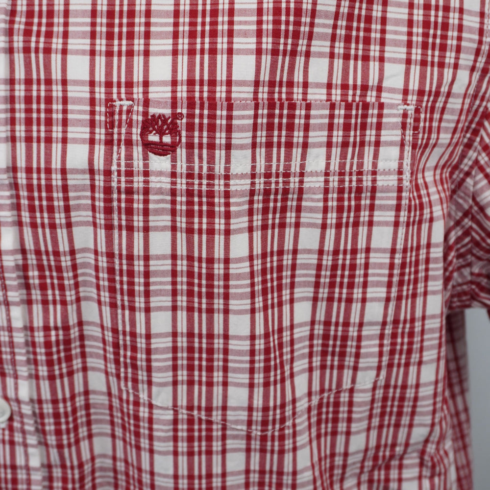 Ingrandimento del taschino sul petto con il classico logo dell'albero Timberland ricamato in filo rosso a contrasto.