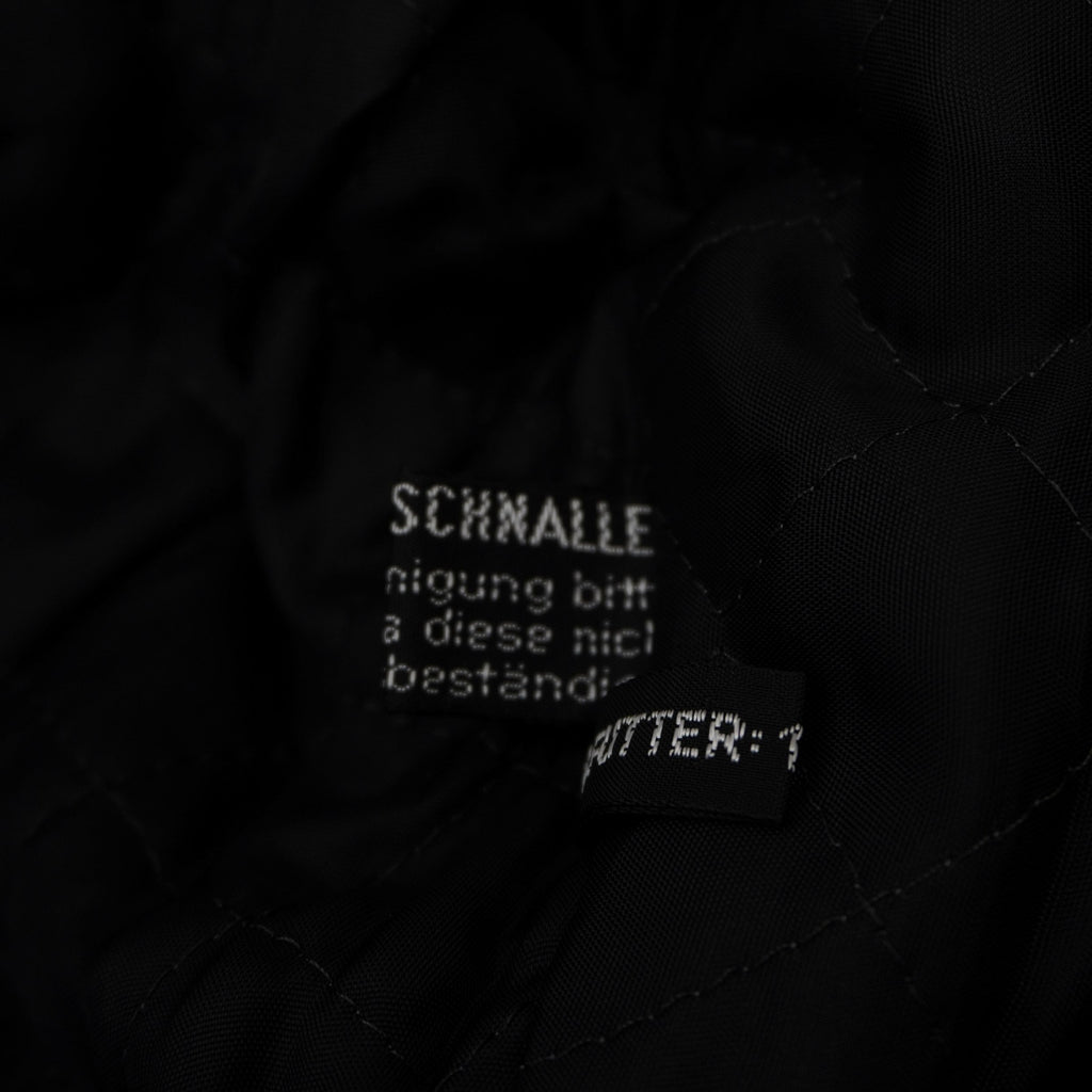Etichetta di composizione tedesca che certifica il tessuto esterno in 100% Baumwolle (puro cotone).