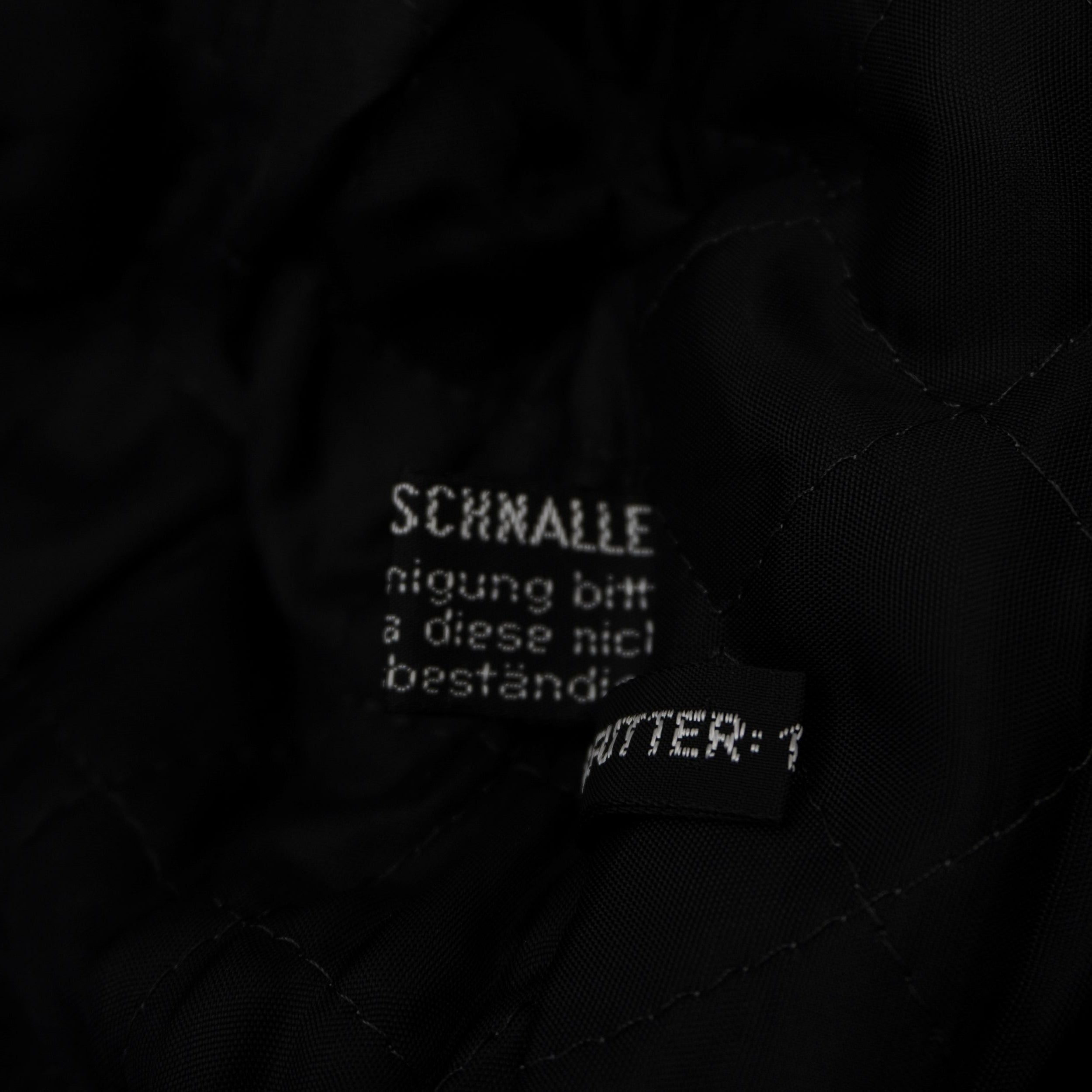 Etichetta di composizione tedesca che certifica il tessuto esterno in 100% Baumwolle (puro cotone).