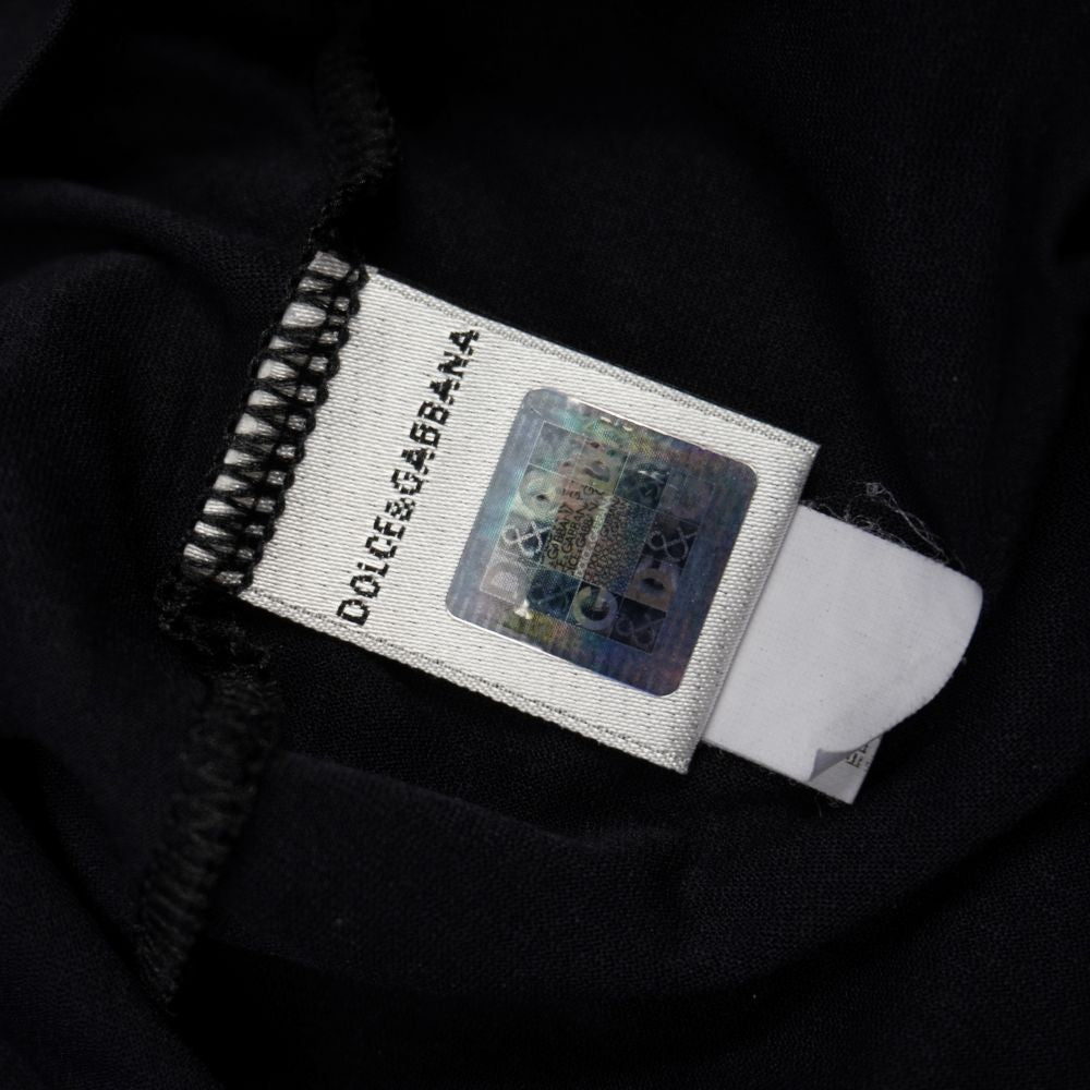 Etichetta interna di autenticità Dolce & Gabbana con ologramma argentato anticontraffazione quadrato e monogramma cangiante di sicurezza.