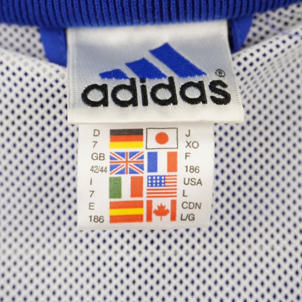 Primo piano dell'etichetta d'archivio adidas applicata sulla fodera interna in mesh bianca traspirante.