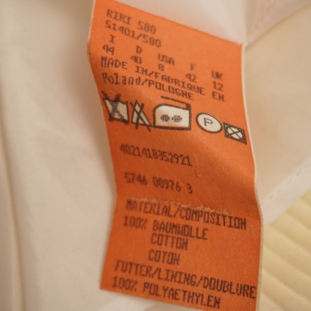 Etichetta interna arancione della gonna HUGO Boss che mostra la composizione 100% cotone e la taglia italiana 44.