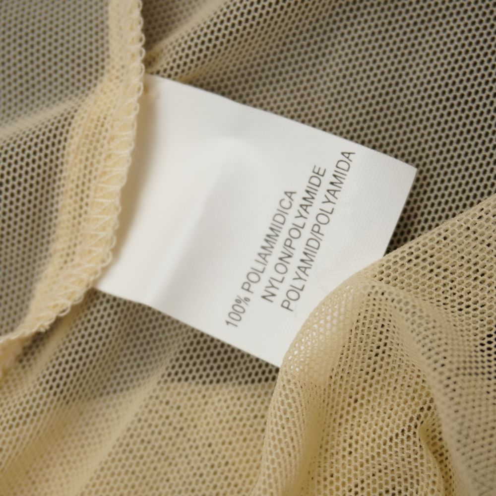 Etichetta interna bianca che riporta la composizione del tessuto in 100% poliammidica nylon su trama a rete.