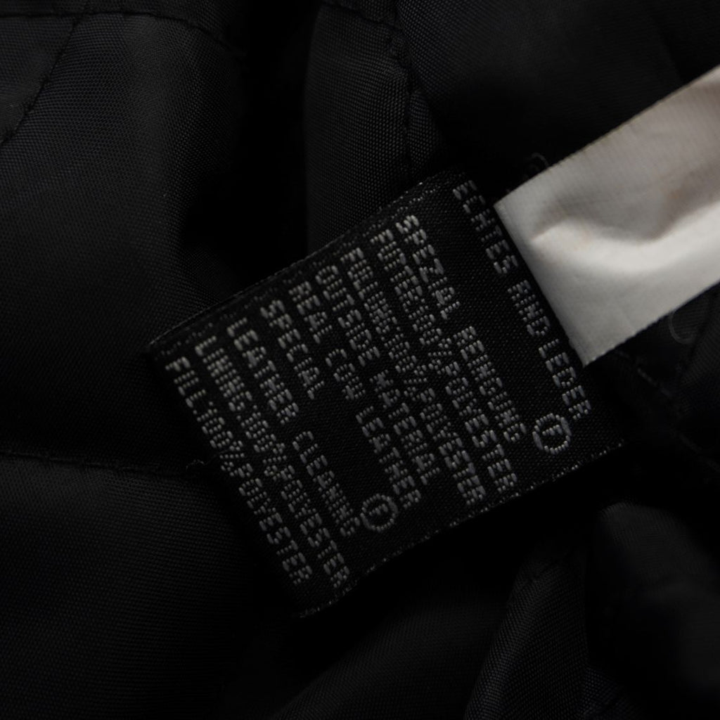 Vista dell'etichetta interna nera che certifica la composizione in vera pelle bovina (Real Cow Leather).