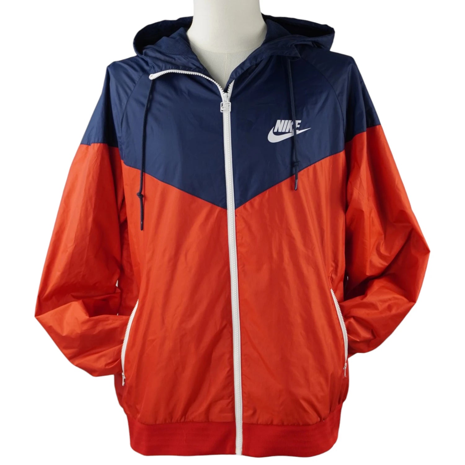 Giacca a vento Nike Sportswear Windrunner originale bicolore blu navy e arancione con cappuccio e iconico design a V sul petto.