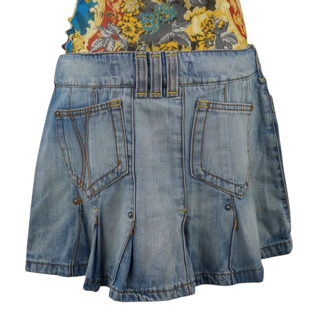 Inquadratura posteriore della gonna di jeans a pieghe Extyn con tasche sagomate e triplo passante centrale.