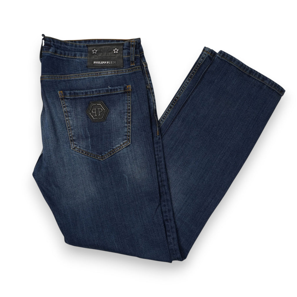 Vista laterale dei jeans da uomo Philipp Plein Couture piegati a metà con focus sulla tasca posteriore logata