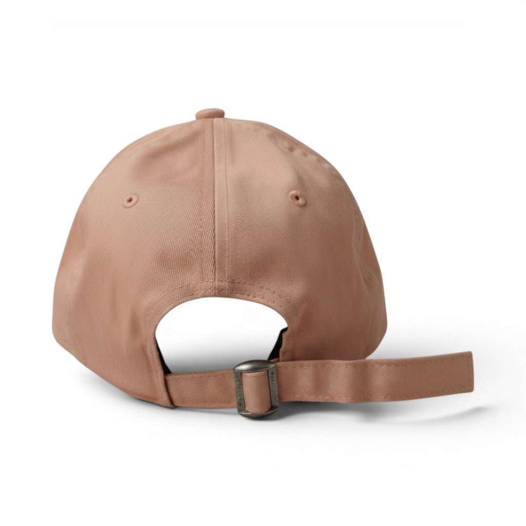 Vista posteriore regolabile di un cappellino rosa New Era 9FORTY con chiusura cloth strap in tessuto e fibbia metallica.