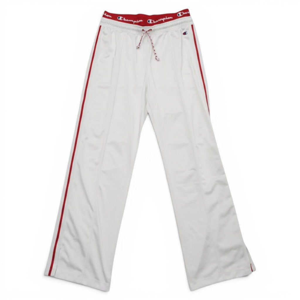 Vista frontale dei track pants Champion bianchi, taglio a gamba dritta e vita elastica rossa a contrasto.